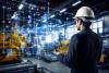 Visuel d'un homme en train de travailler sur sont ordinateur face au risques cyber symbolisés par des traits (les flus) et par des pictogrammes