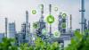 Image montrant des cheminées d'usine avec au premier plan des pictogrammes symbolisant le recyclage